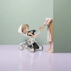 White baby stroller with colorful sunshade, black seat and yellow push rod details Picture